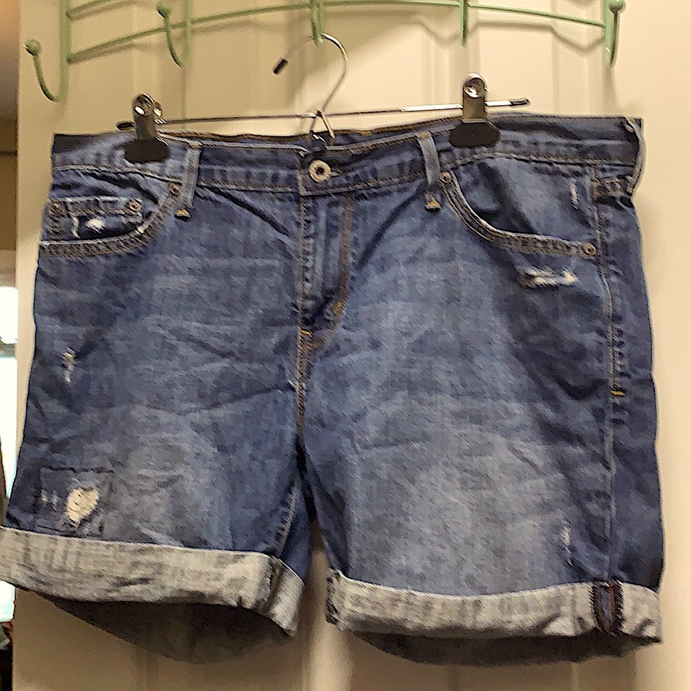 Ripped, light colored, Levi denim shorts.